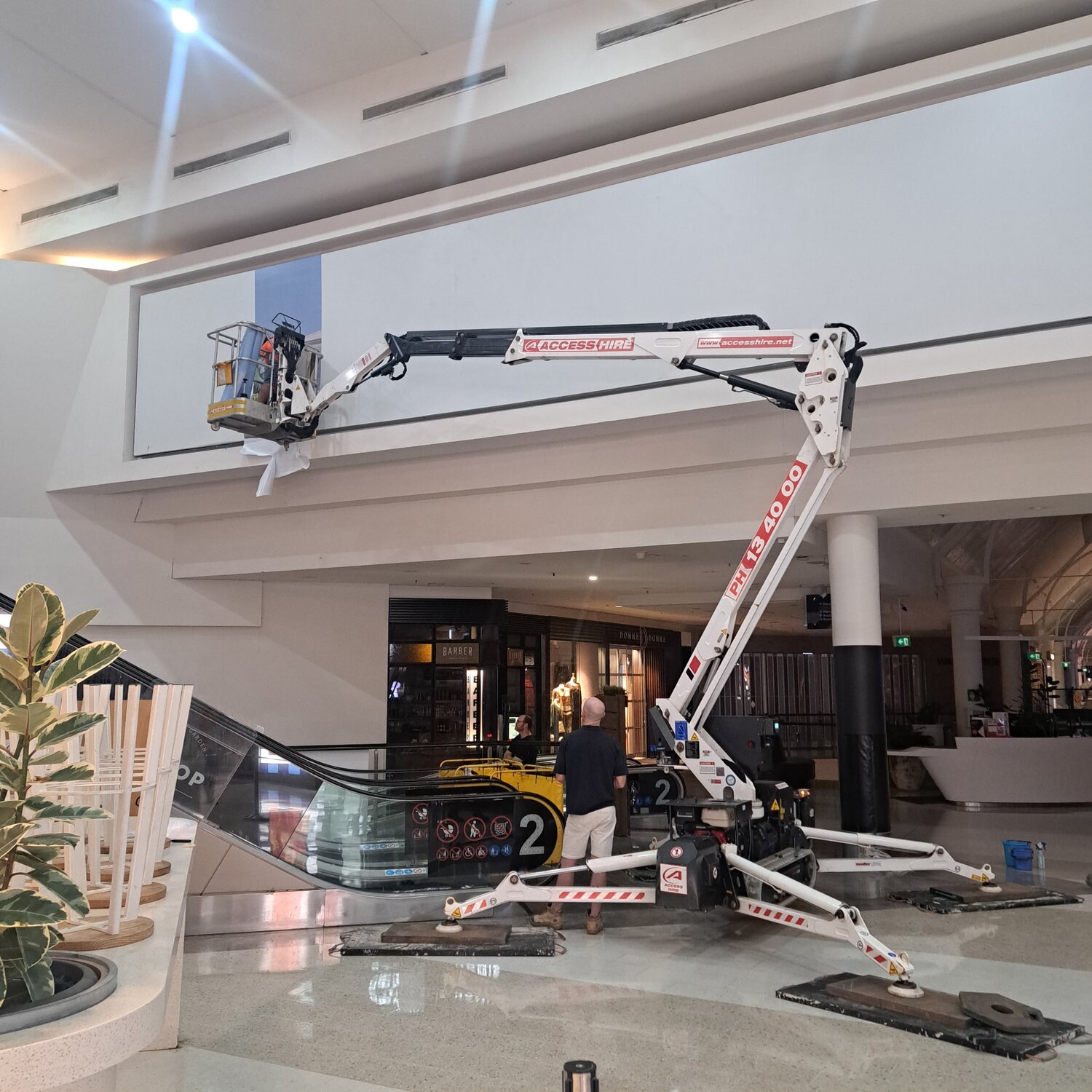 Access Hire spider boom lift in use inside a shopping centre in Newcastle, NSW.