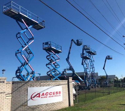 Scissor lifts and a boom lift in operation at the Access Hire Newcastle equipment yard