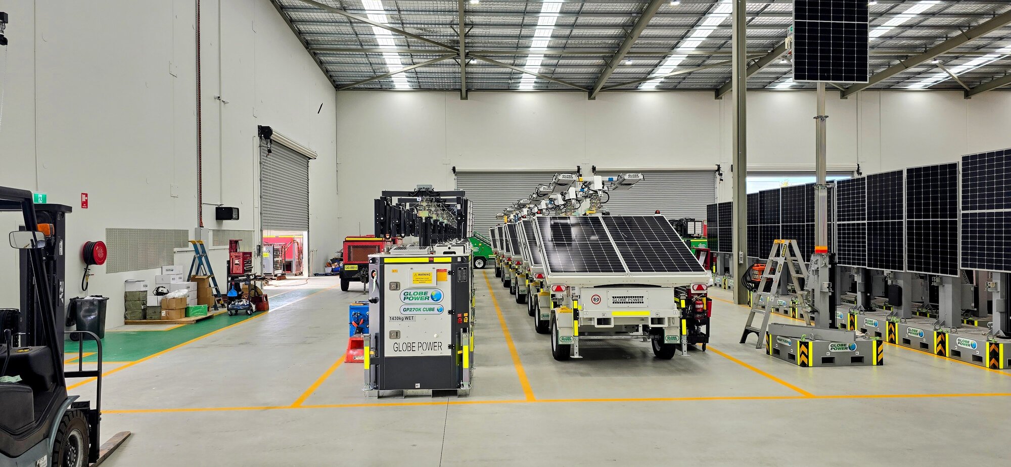 Globe Power solar lighting towers, hybrid power units and portable generators prepared for deployment in the equipment warehouse.