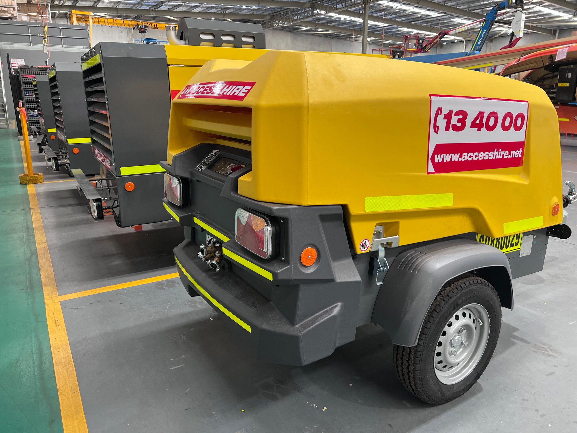 Portable air compressors prepared for hire in the Access Hire equipment workshop.