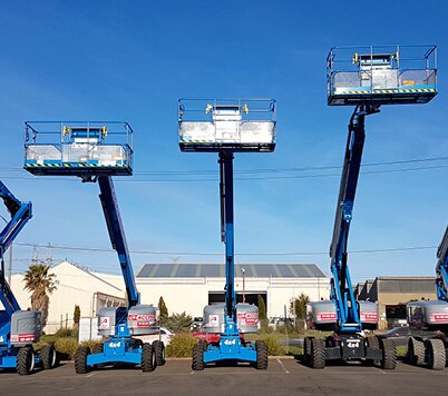 Boom lifts lined up at the Access Hire Melbourne branch with platforms raised