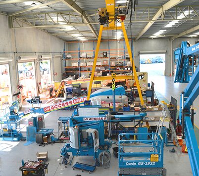 Access equipment undergoing servicing and maintenance inside the Access Hire Perth workshop