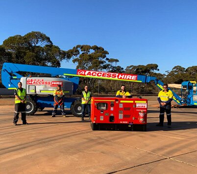 Access Hire Kalgoorlie team members standing with a boom lift and generator