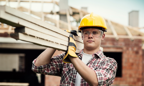 Worker carrying lumber