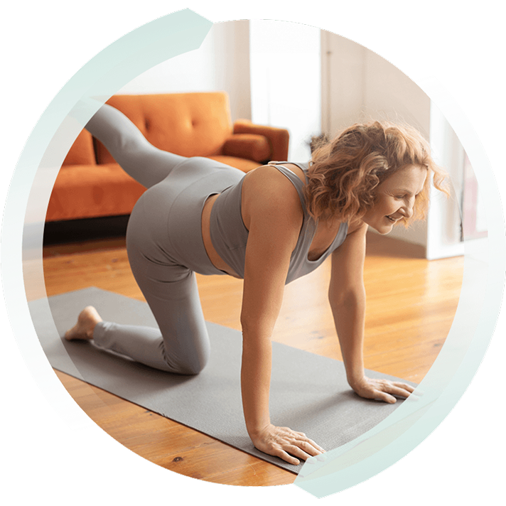 a blond woman doing a yoga pose on a mat