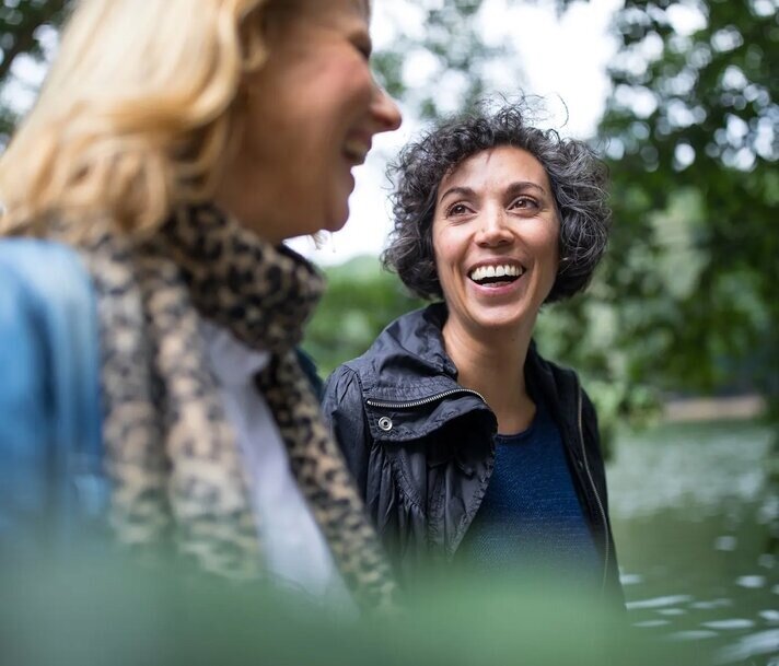 two woman walking and laughing