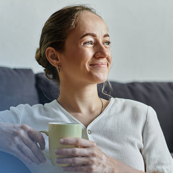 Woman smiling with coffee