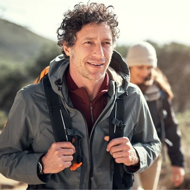 man hiking with a woman walking behind