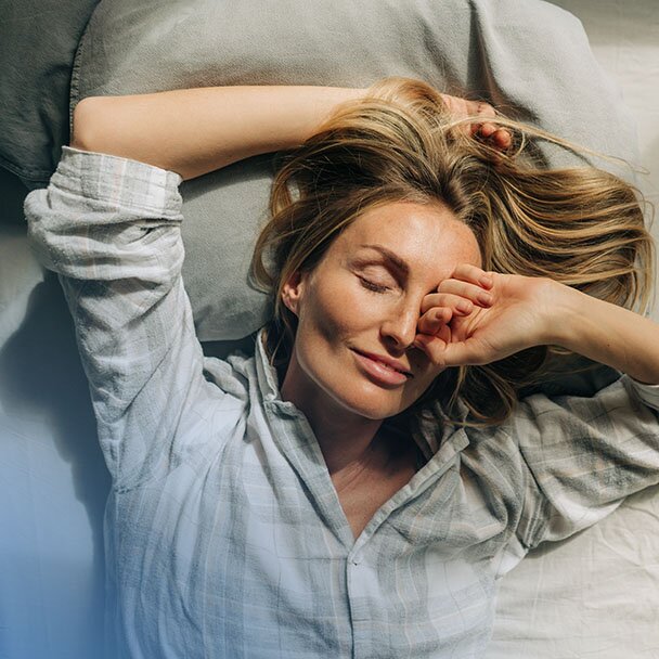 Woman stretching in bed