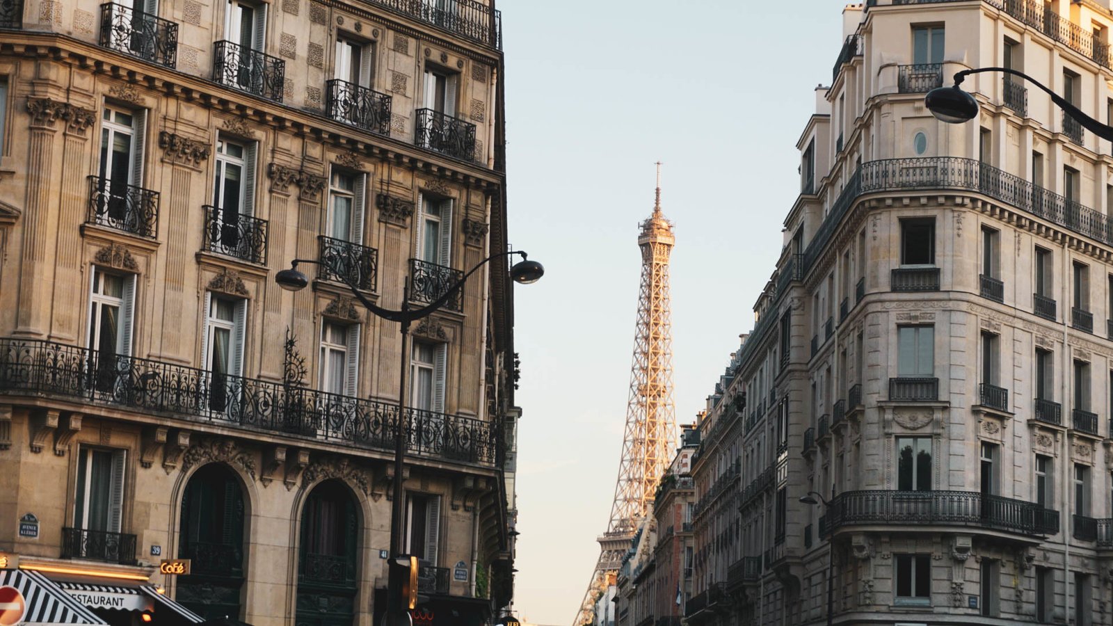 The Eiffel Tower visible between buildings in Paris