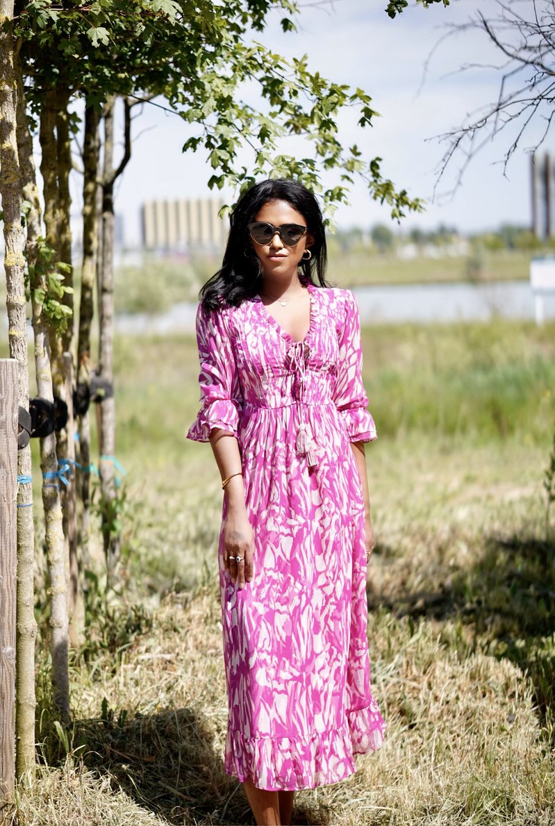 Outdoor picture of Sachini wearing a white and pink River Island midi dress