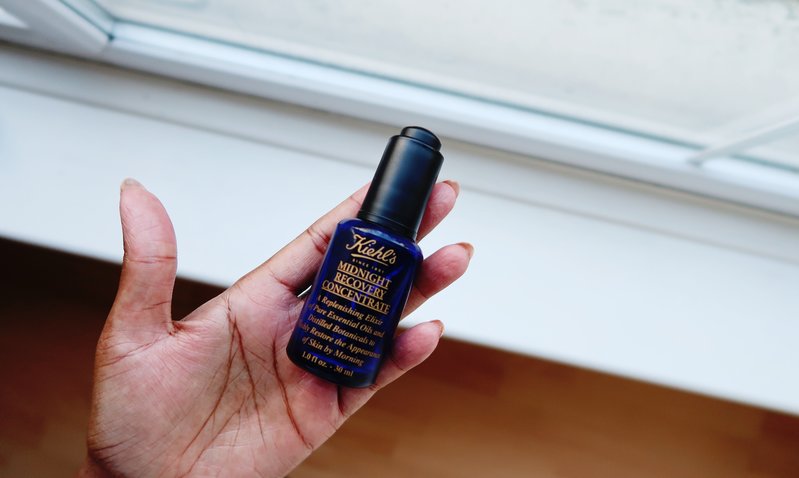 Hand holding Kiehl's Midnight Recovery Night Oil