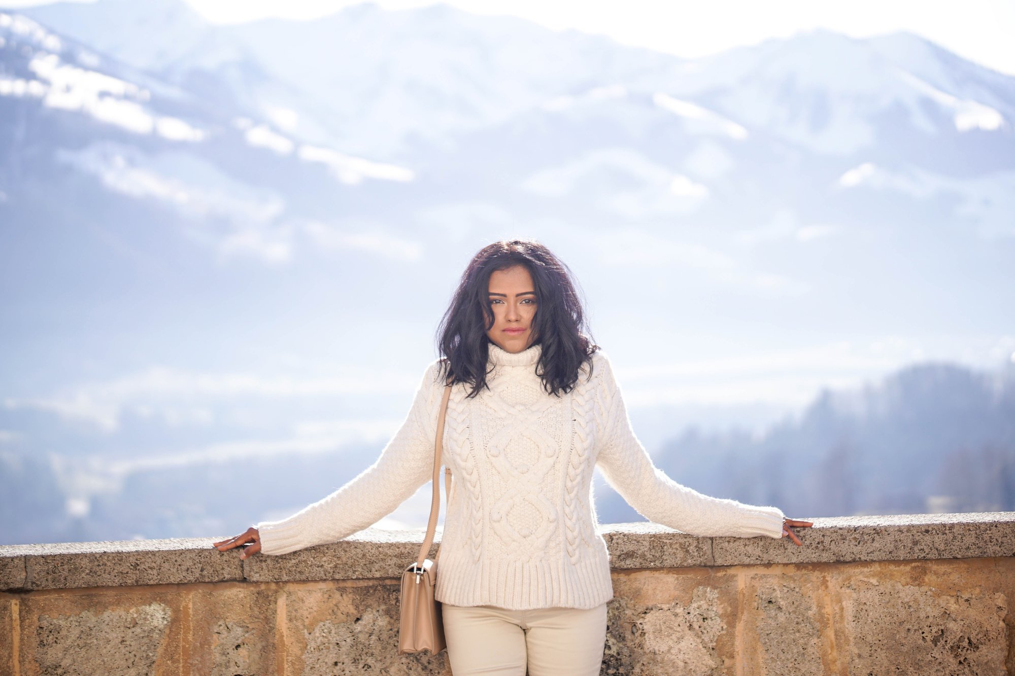 Sachini wearing white in a mountainous environment 