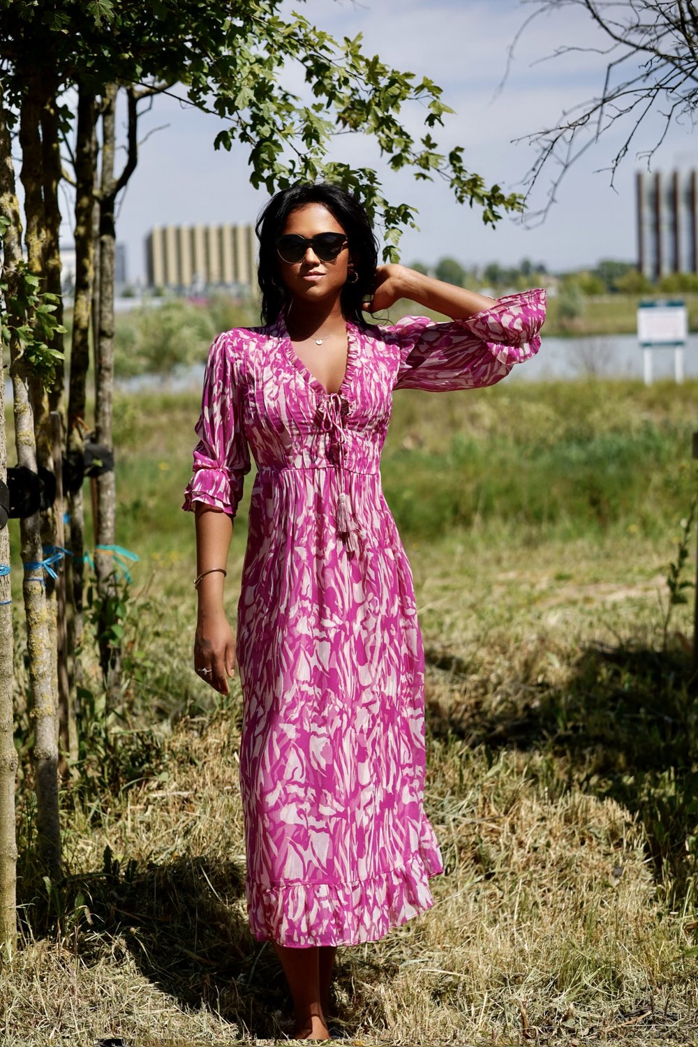 Outdoor picture of Sachini wearing a white and pink River Island midi dress