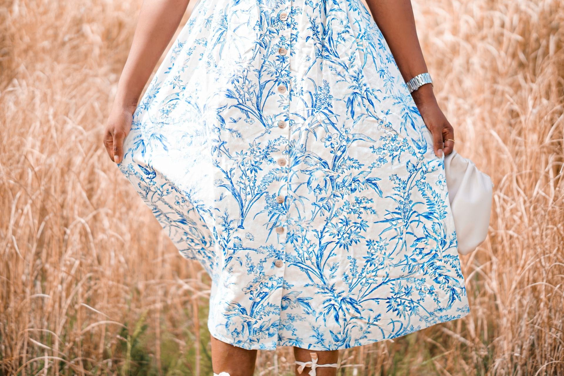 Close up of a white and blue dress in a field 