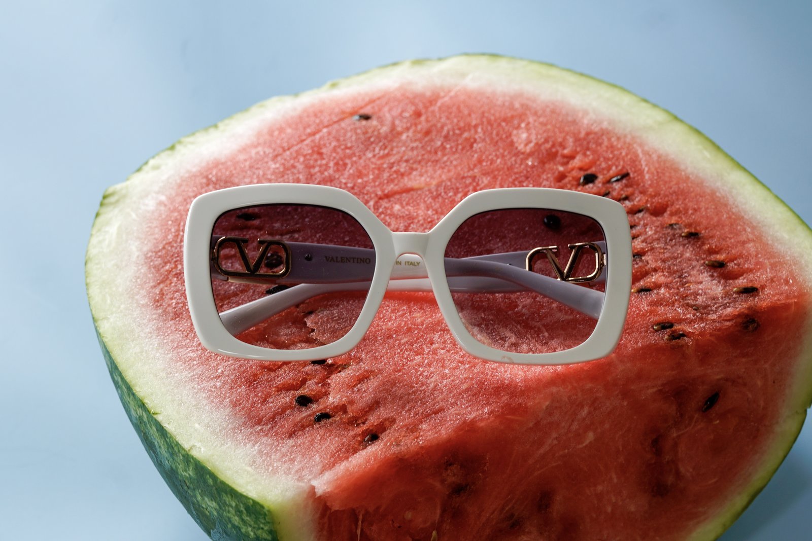 White Valentino sunglasses on top of a watermelon