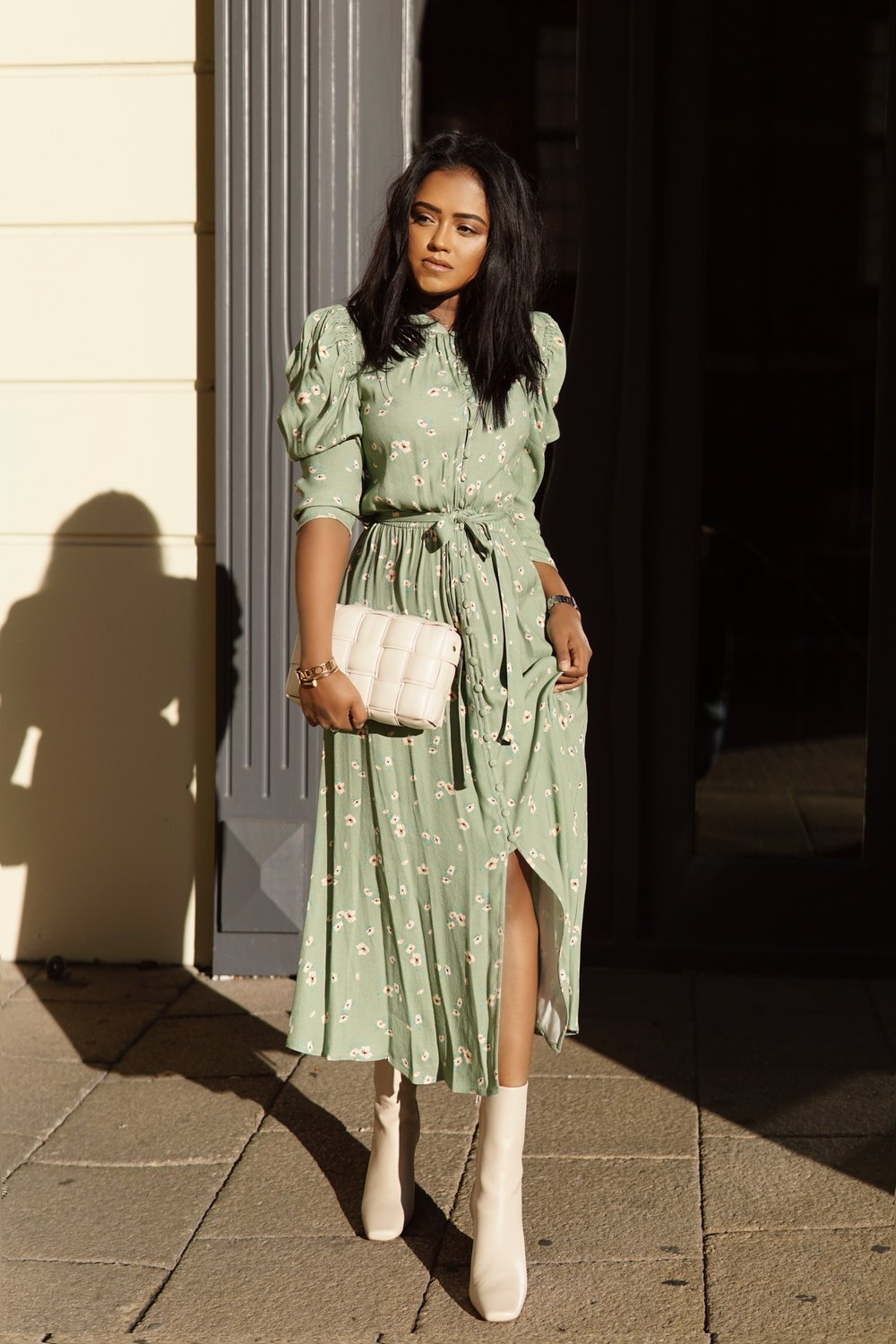 Sachini wearing a green Ghost Fashion dress and white & Other Stories shoes