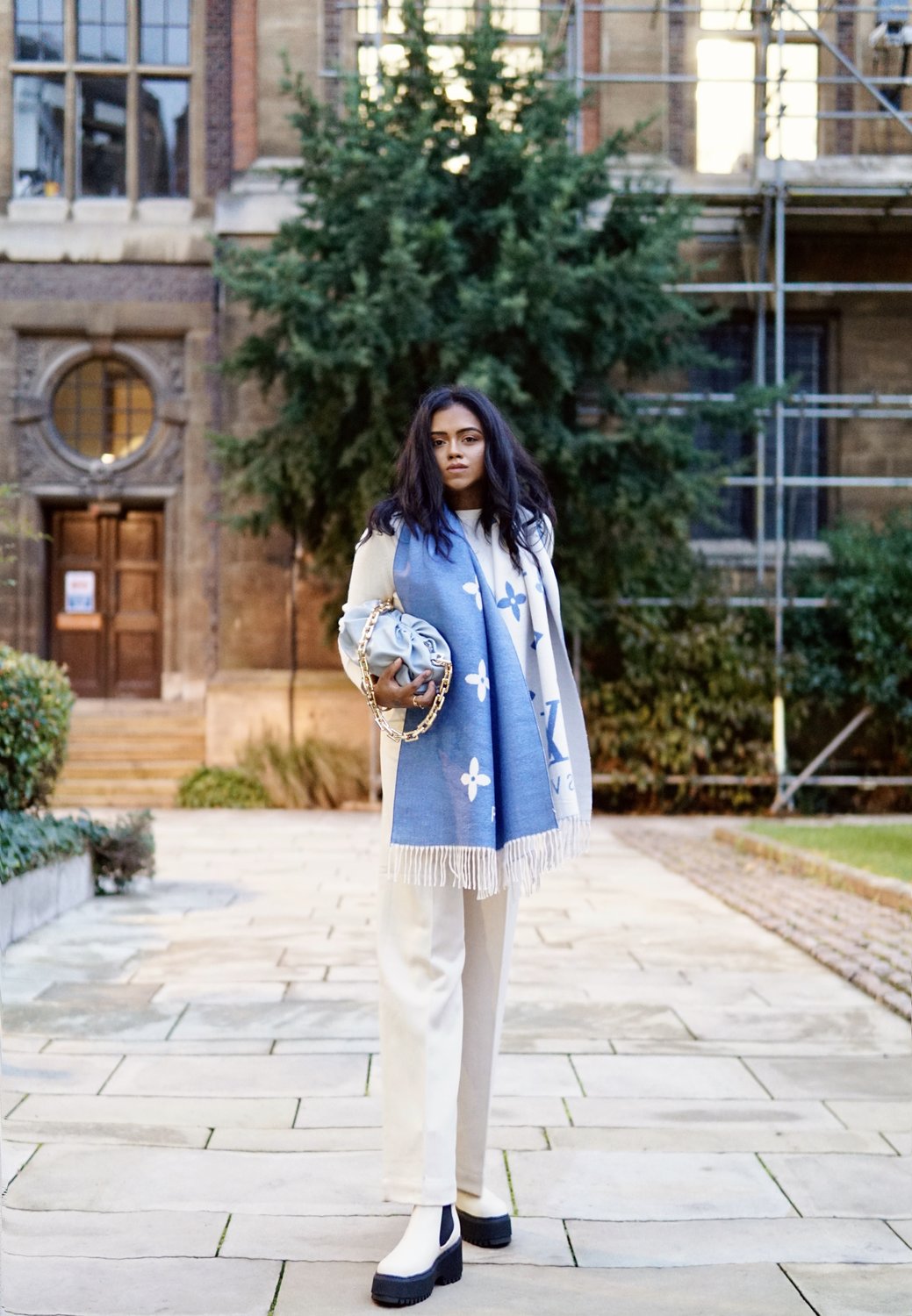 Sachini with a Louis Vuitton scarf, white trousers and & Other Stories boots