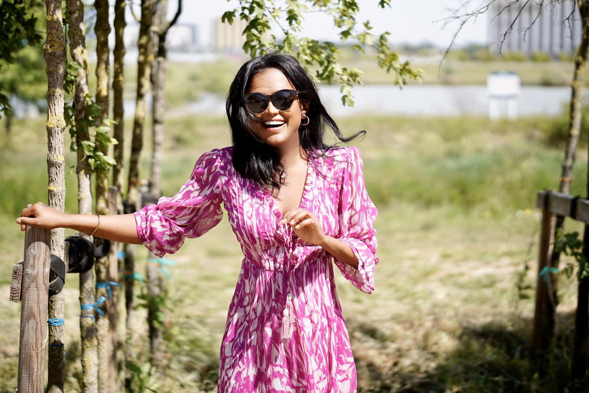 Outdoor picture of Sachini wearing a white and pink River Island midi dress