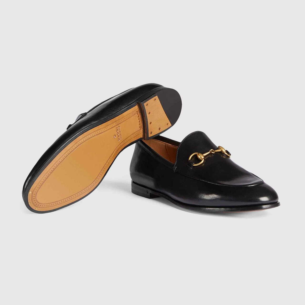 Close up of black Prada loafers