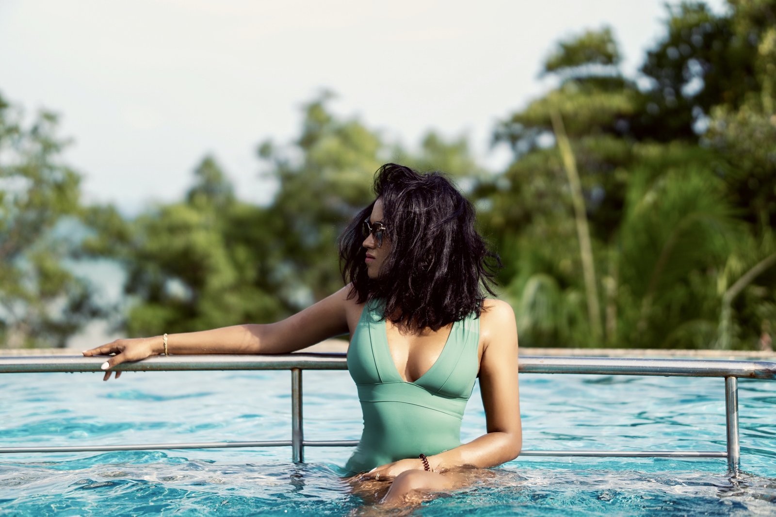 Sachini wearing a turquoise swimsuit in a swimming pool