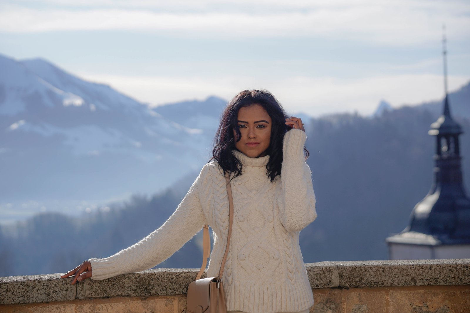 Sachini wearing white in a mountainous environment 