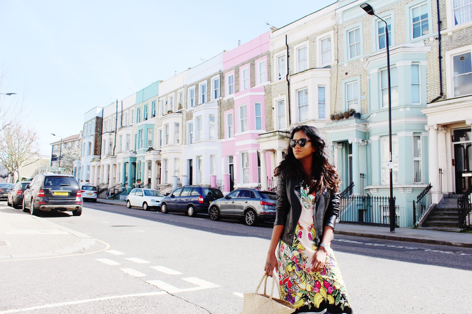 Sachini wearing a black leather jacket and floral dress