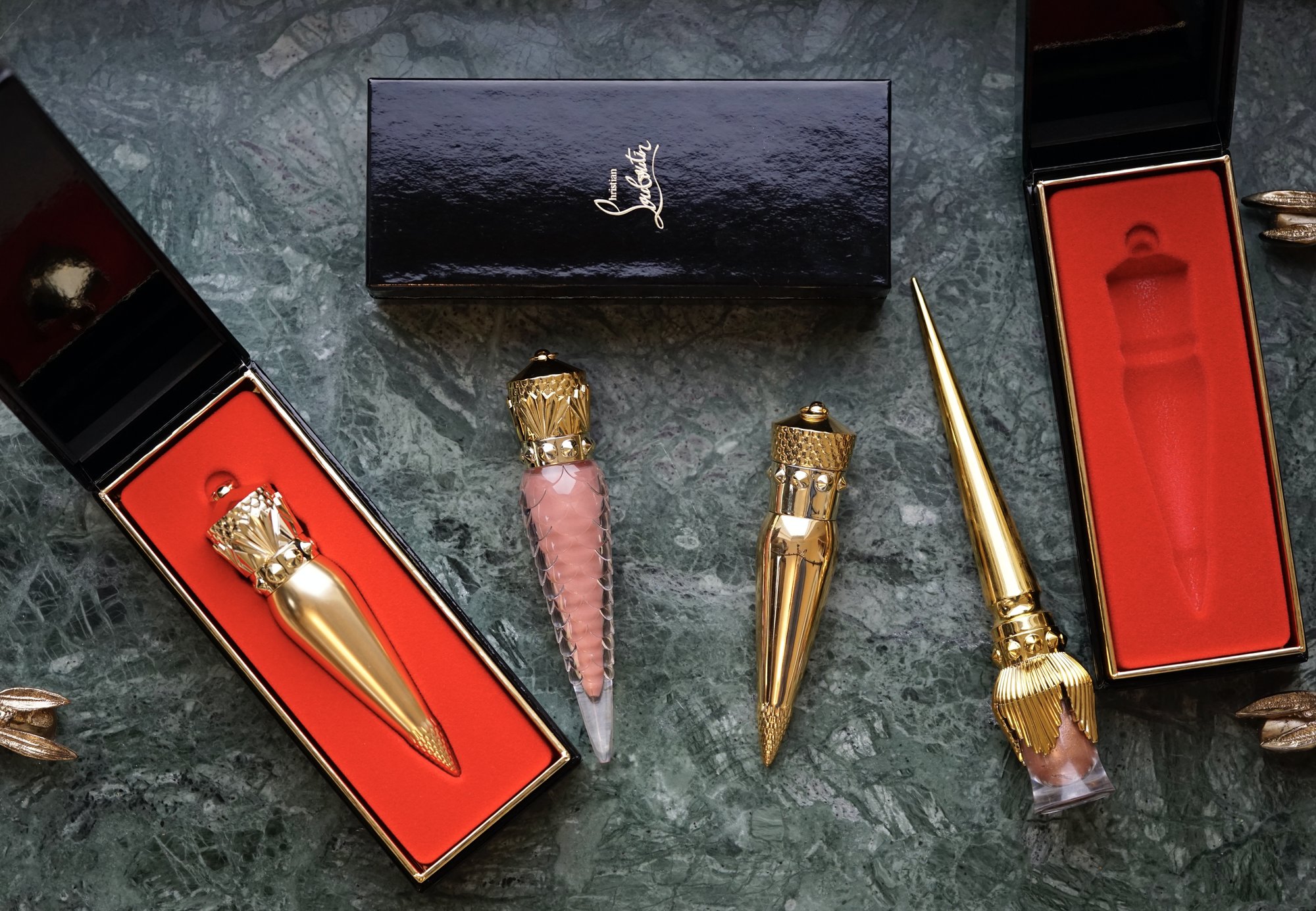 Closeup of multiple Christian Louboutin beauty items