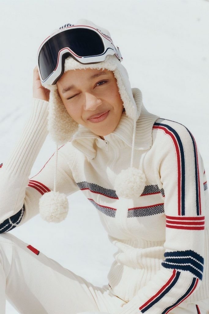 Close up of a model sitting in the snow wearing Dior Alps collection