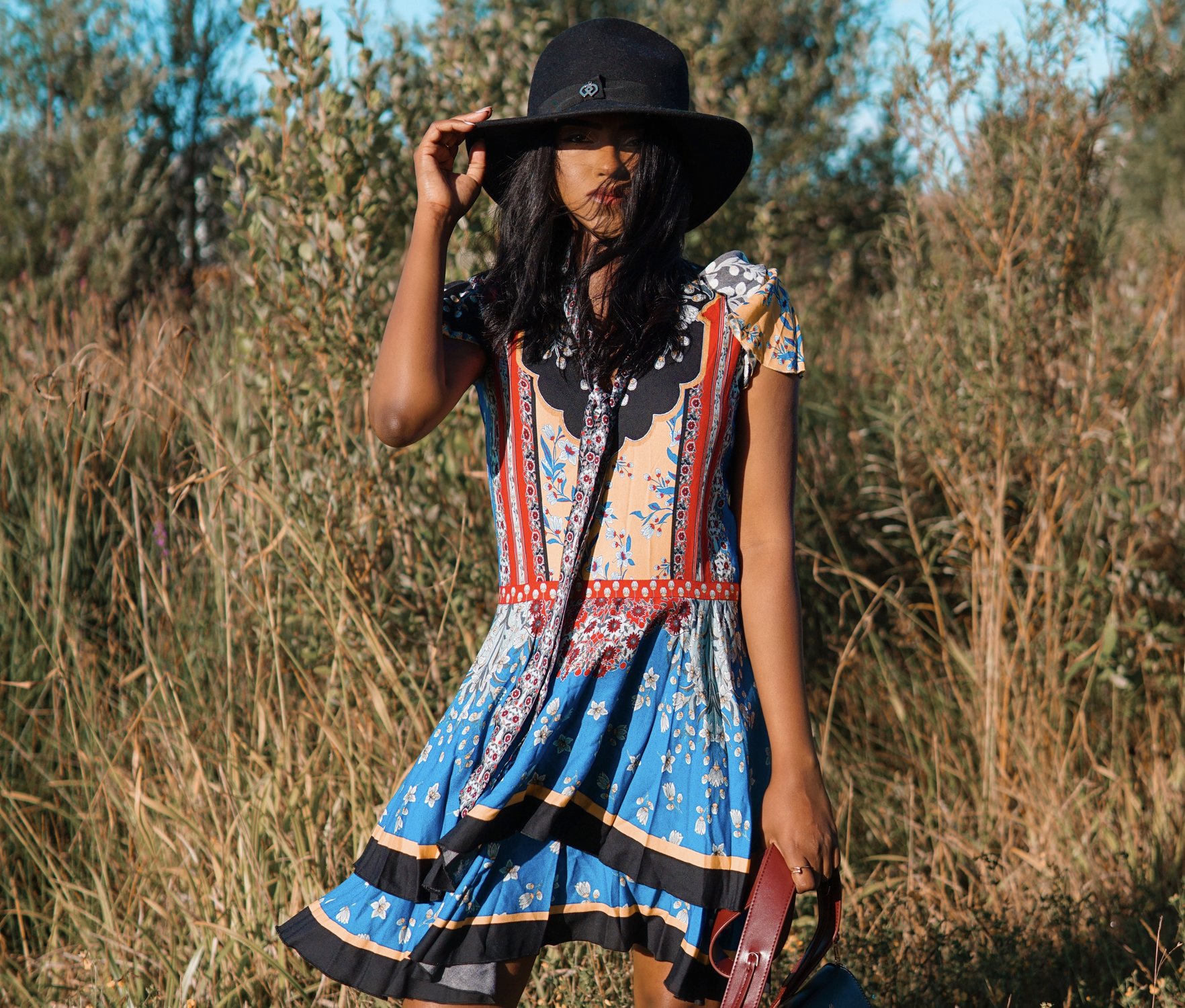 Sachini wearing a Alice and Olivia dress and black hat