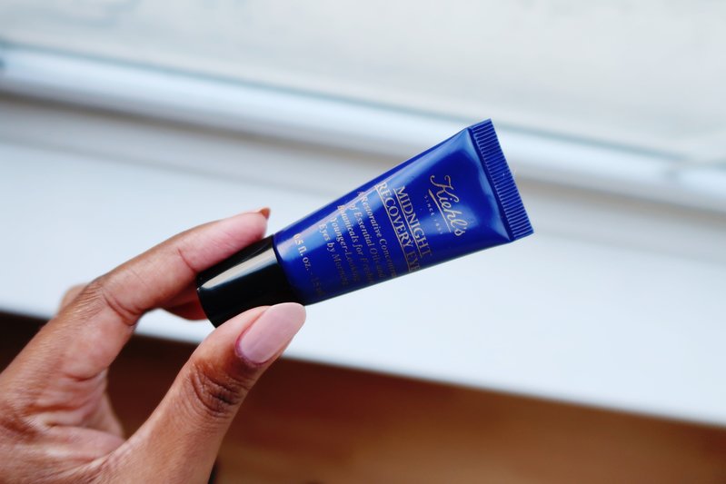 Hand holding Kiehl's Midnight Recovery Eye Cream