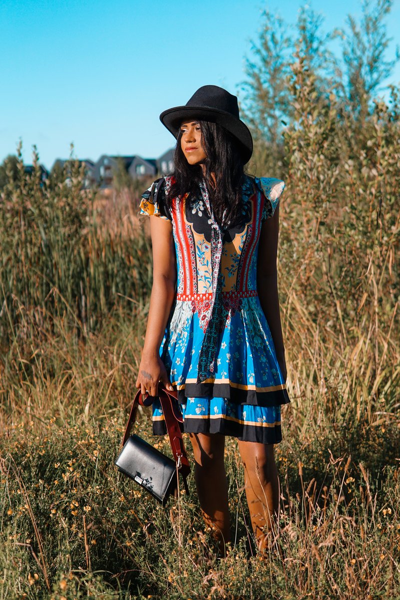 Sachini wearing a Alice and Olivia dress and black hat
