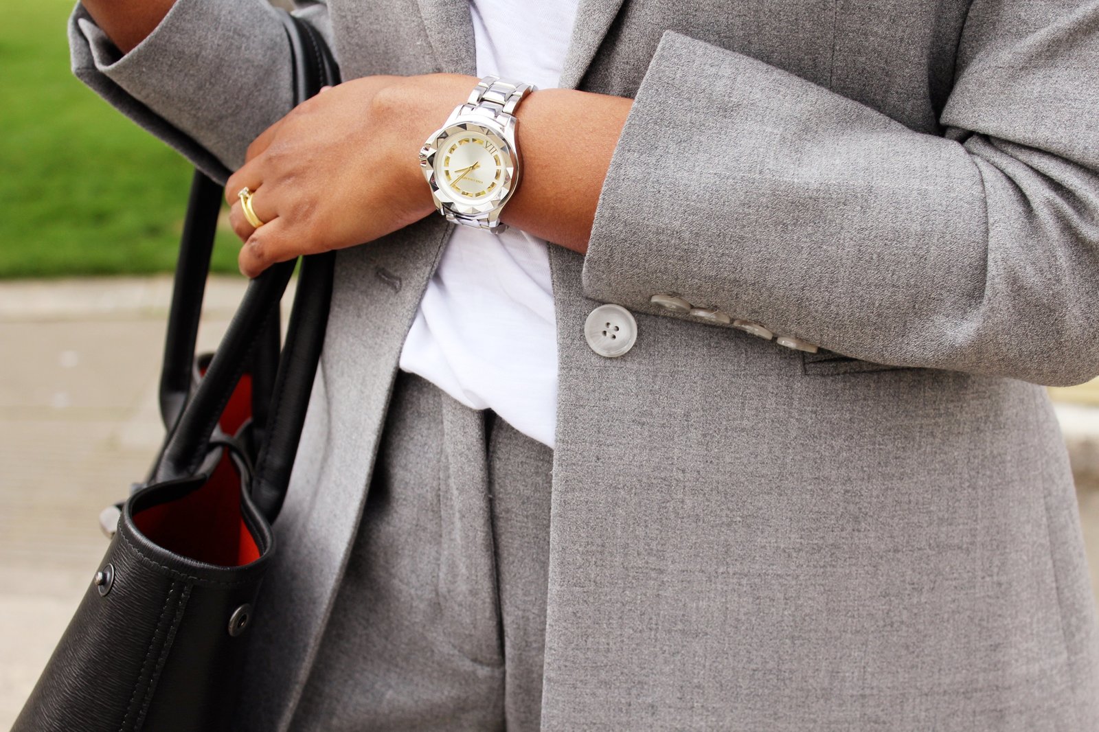 Close of Sachini wearing a grey suite and watch