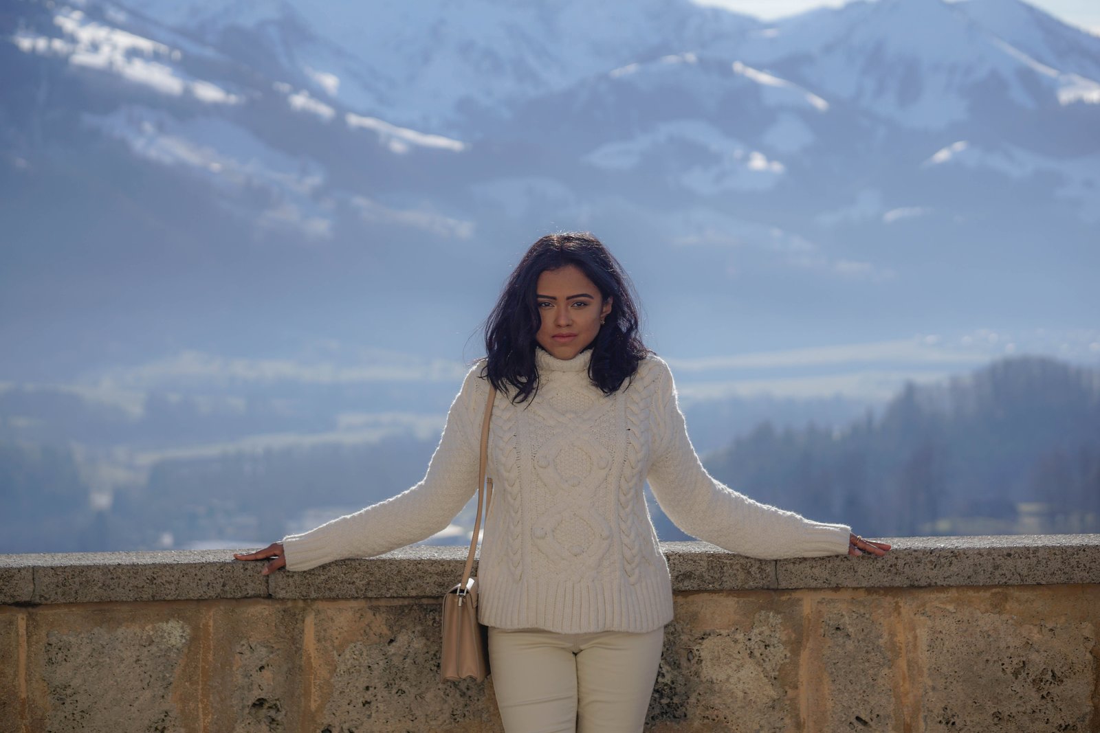 Sachini wearing white in a mountainous environment 