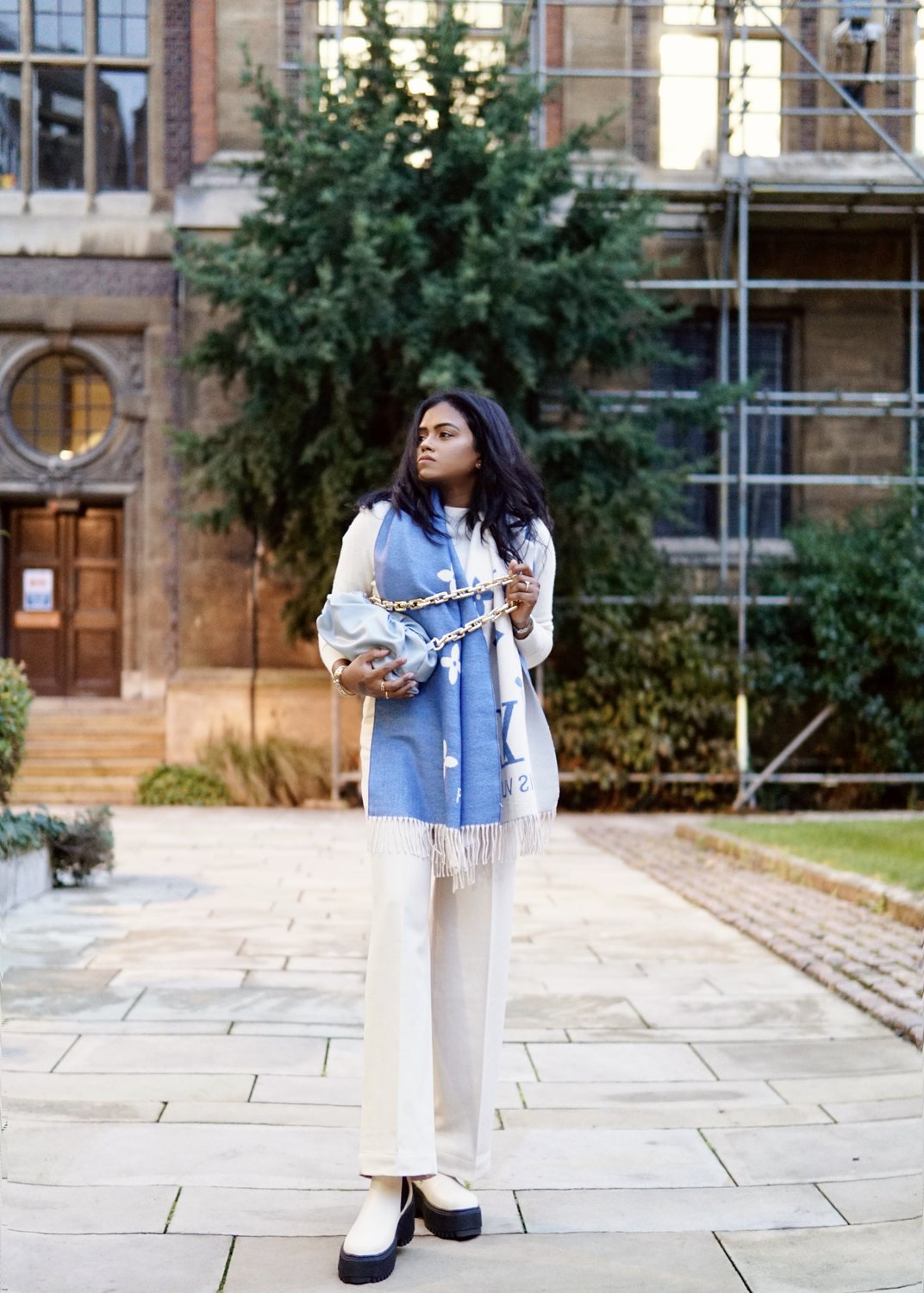 Sachini with a Louis Vuitton scarf, white trousers and & Other Stories boots