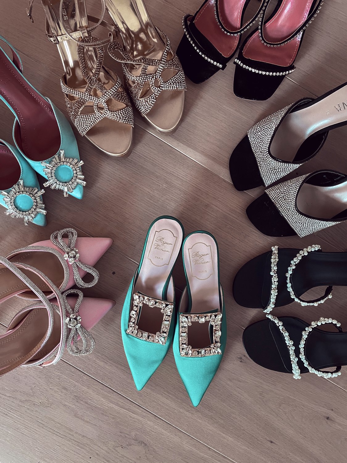 7 party shoes in a circle on a wooden floor