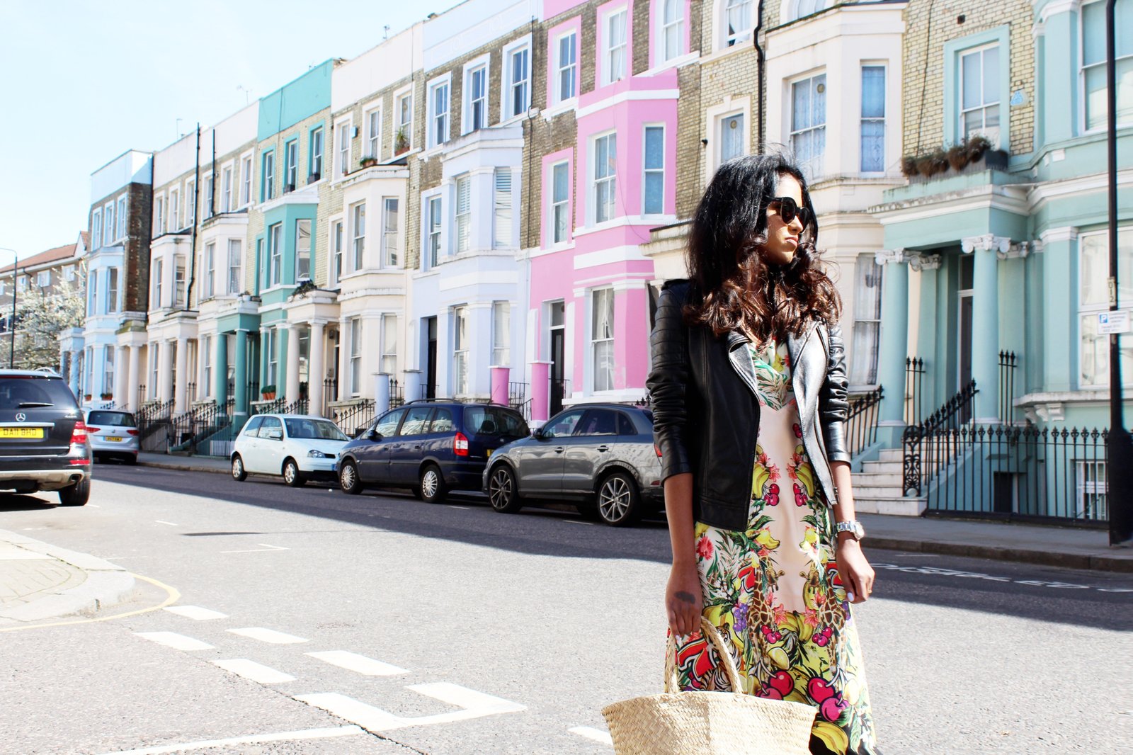 Sachini wearing a black leather jacket and floral dress