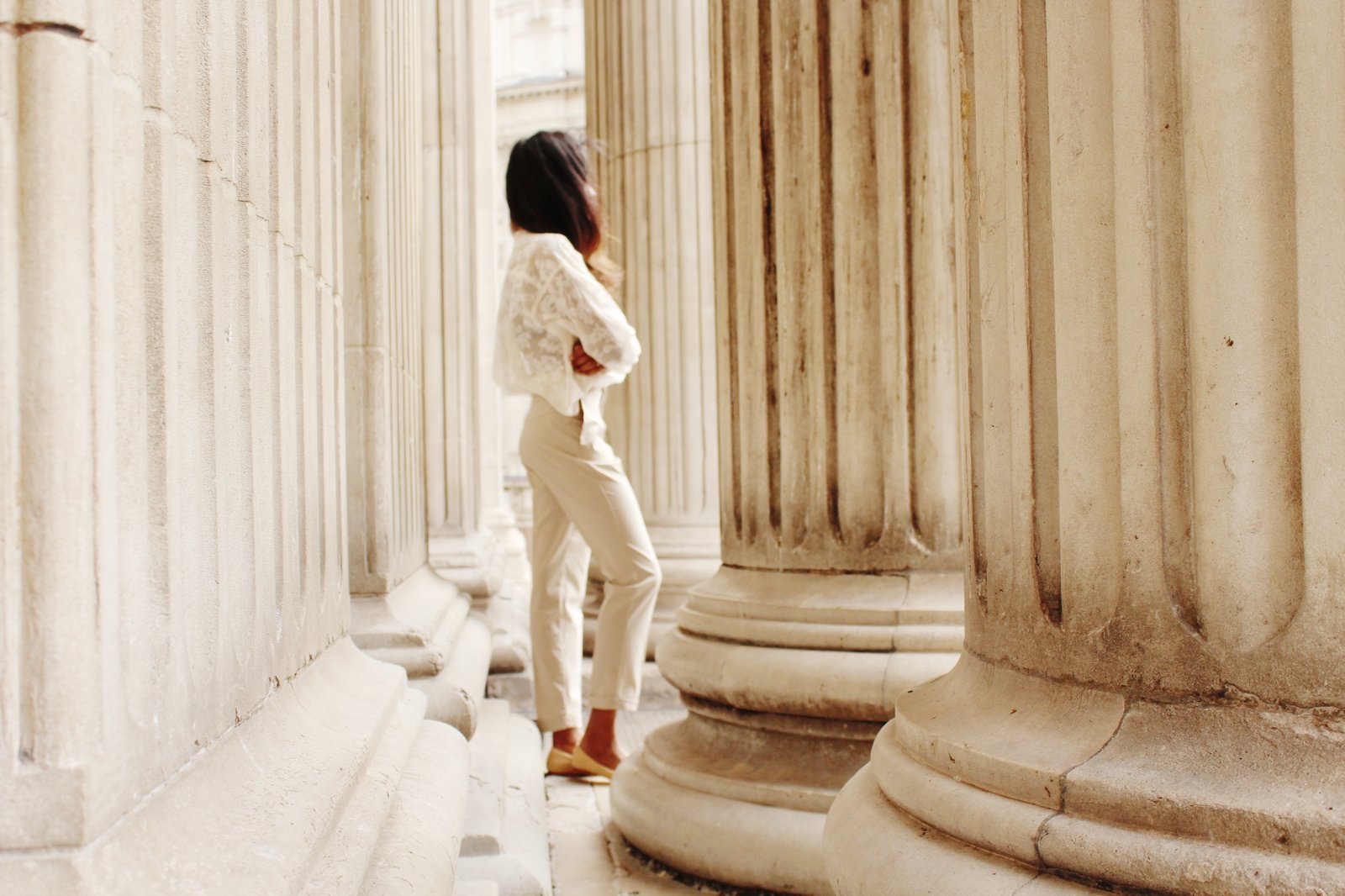 Side shot of Close up of Sachini wearing a white top and beige trousers 