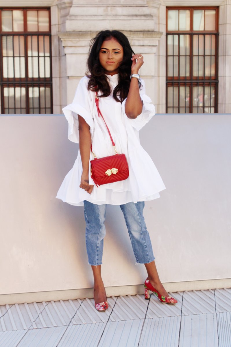 Sachini wearing a white dress, red Gucci shoes and Levi's jeans