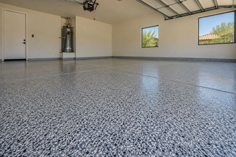 Garage with a speckled full-flake epoxy floor and white walls