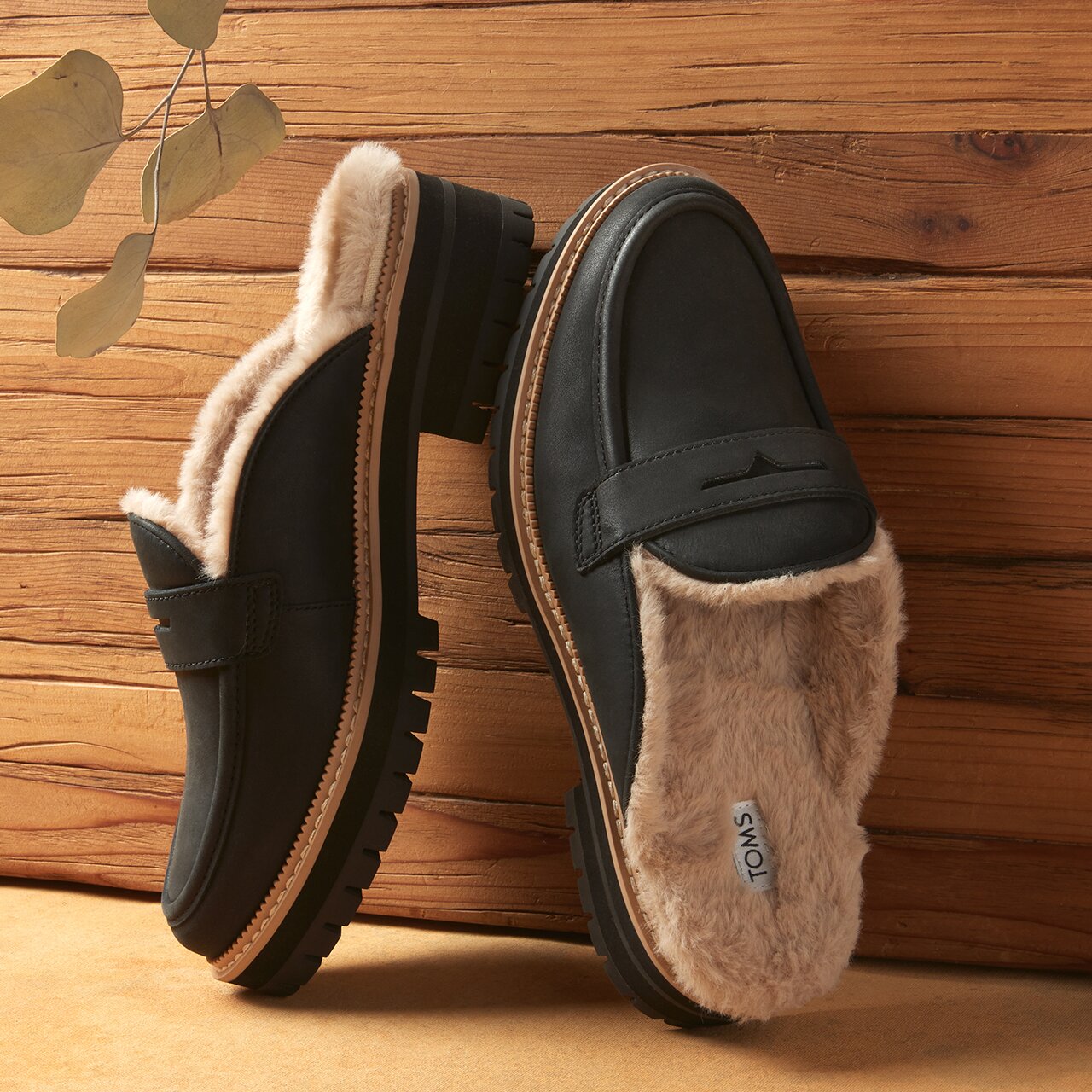 Women's Cara Mule Cozy Loafer in black faux fur leather shown.