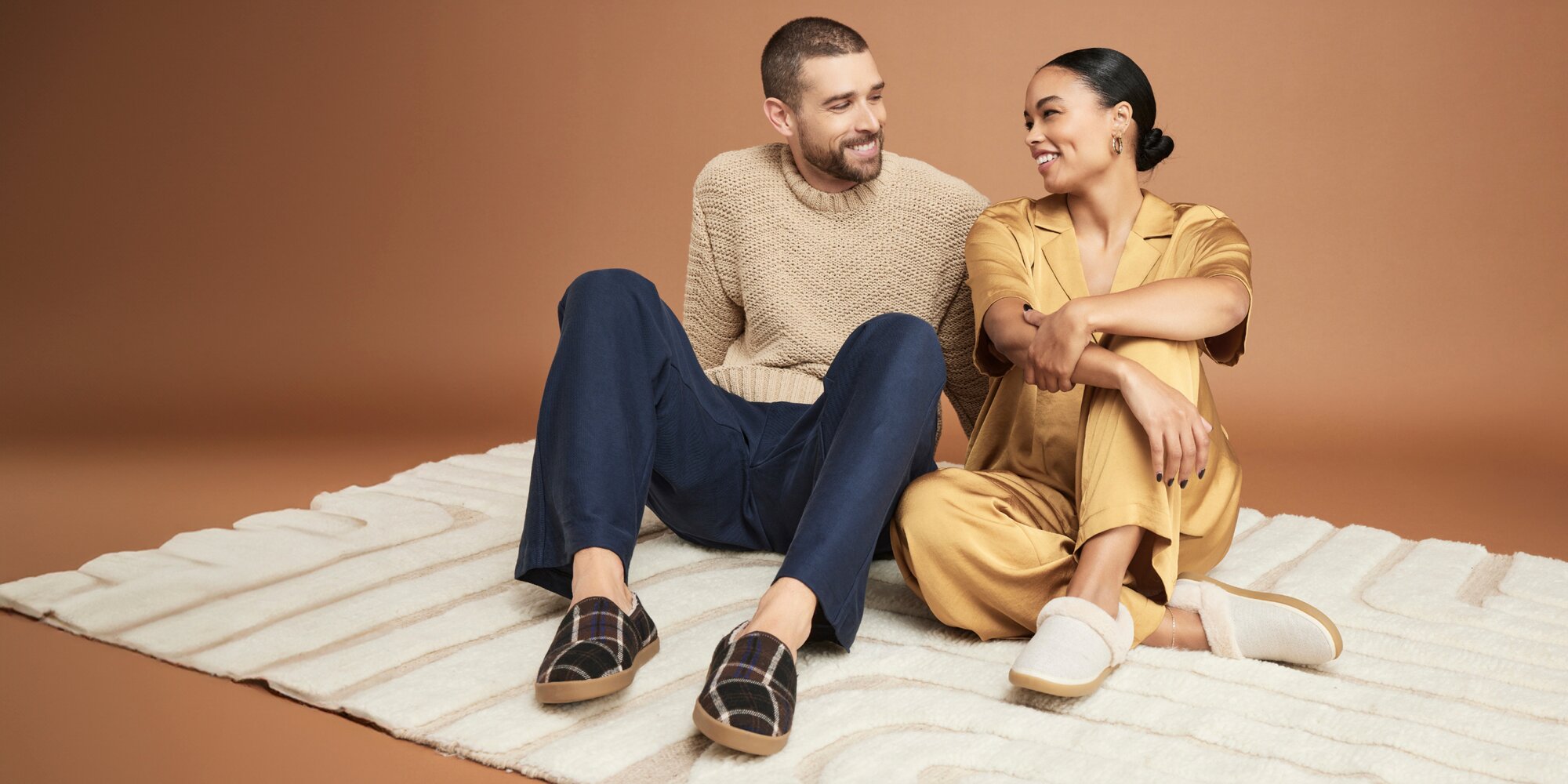 Women's Oslo and men's Camden Slippers in various colors shown.