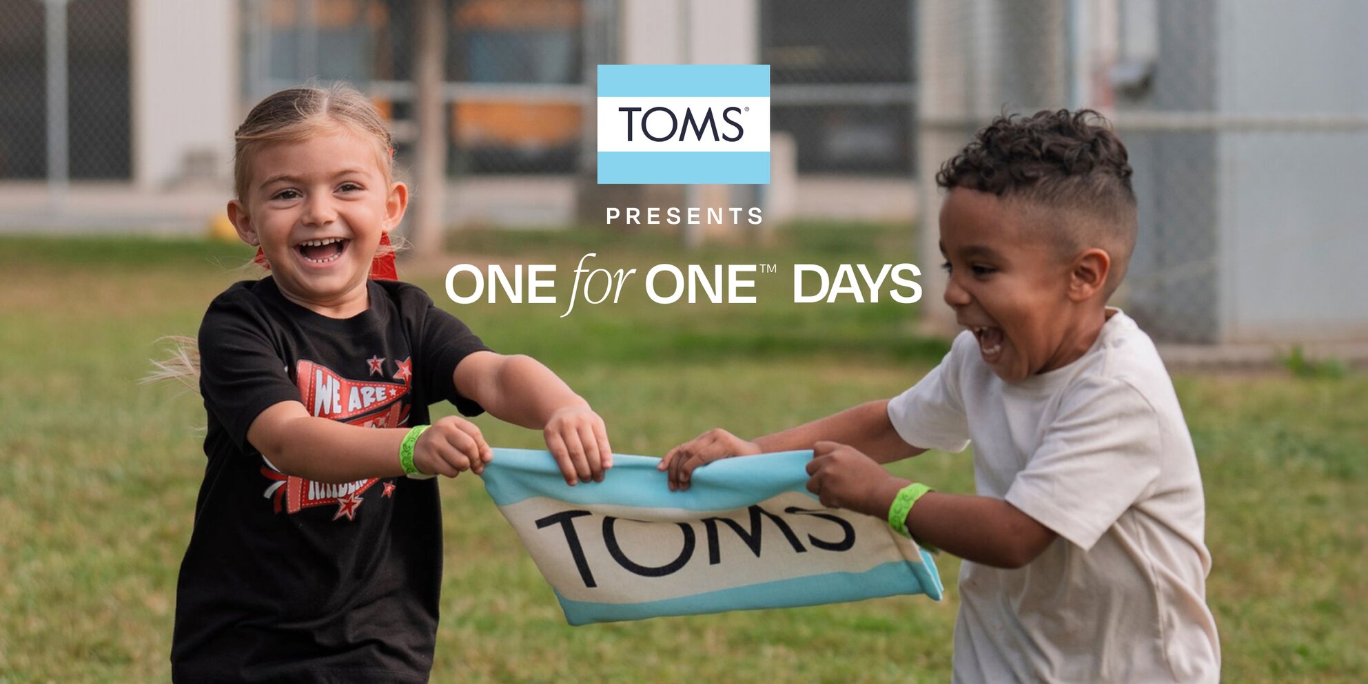 Children holding hands and smiling.