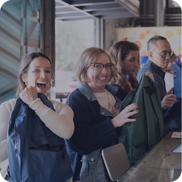 TOMS employees smiling shown.