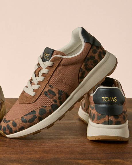 Women's TRVL LITE Retro Runner Sneaker in water repellant brown sugar leopard print suede shown.