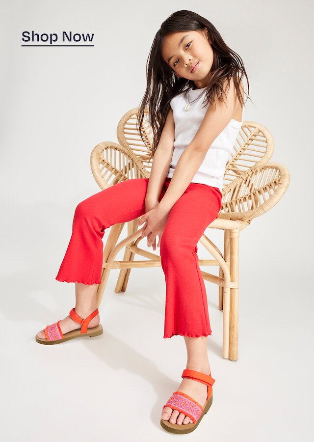 Model wearing kids' Remi Ankle Strap Toddler Sandal in flame diamond global strap shown. Shop Now.