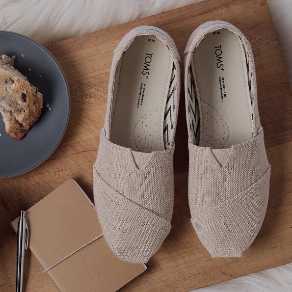 Various TOMS footwear shown.
