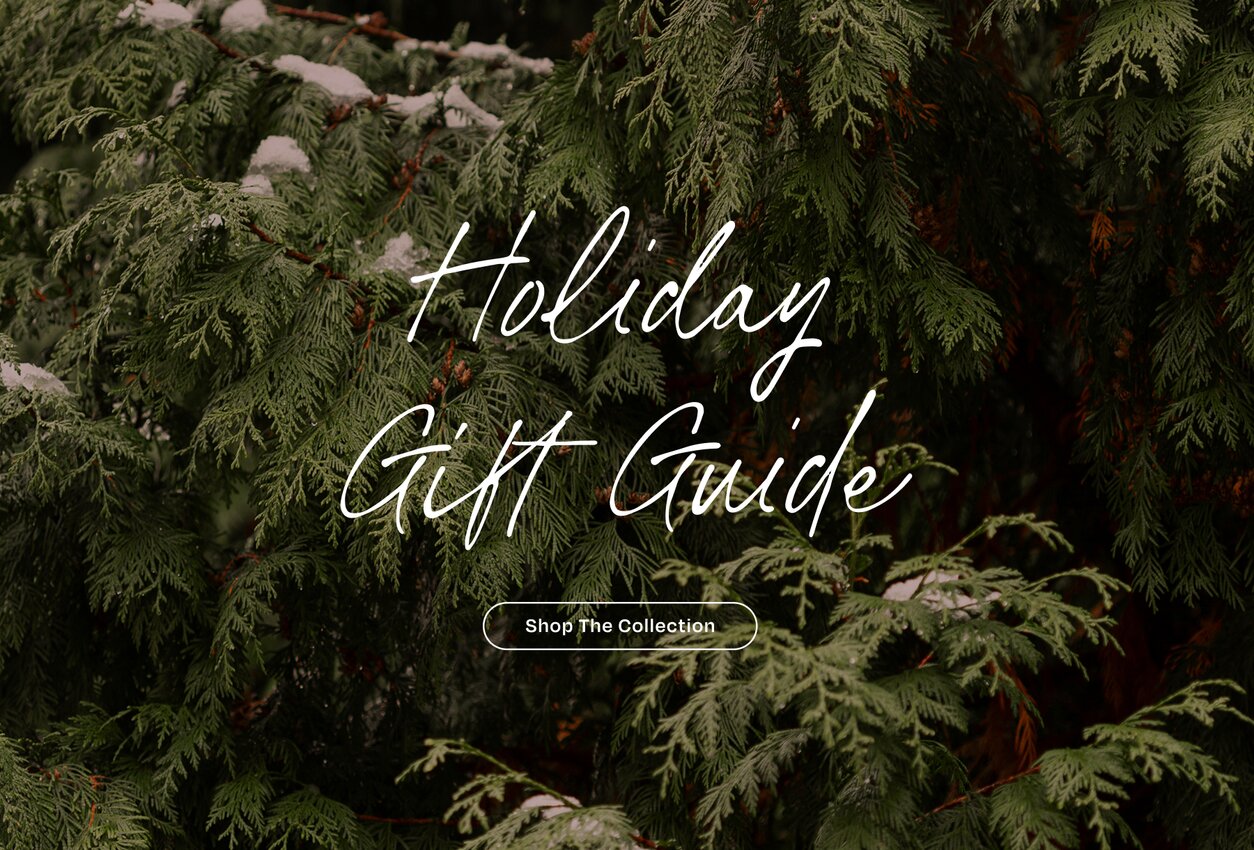 Holiday Gift Guide. Shop the Collection. Closeup of fir tree.