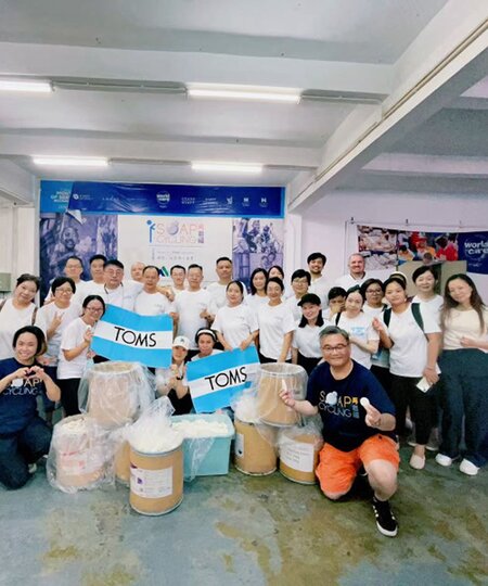 A group of TOMS employees shown.