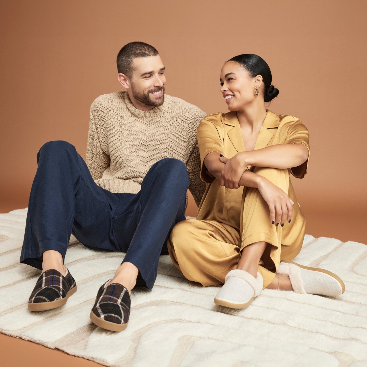 Women's Oslo and men's Camden Slippers in various colors shown.